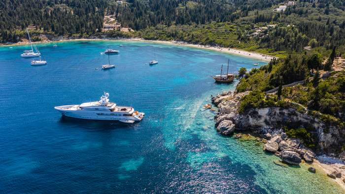 Aerial shot of luxurious boats next to Kipiadi beach at Paxos, Greece_tn