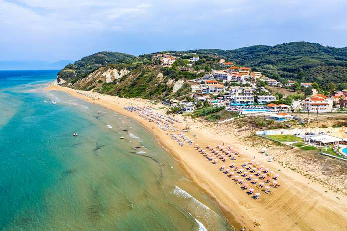 Aerial drone view of Agios Stefanos beach, a small tourist resort on the north east coast of Corfu in Greece_tn