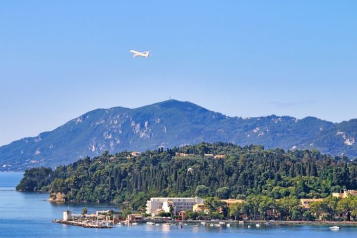 Passenger Airplane Taking Off Over Kanoni Coastline in Corfu Greece