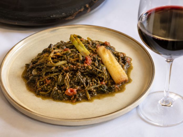 Traditional Corfiot tsigareli with wild greens and tomato
